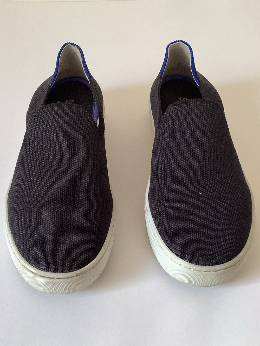 Rothy’s Slip-On Canvas Sneakers in Black with Blue Trim